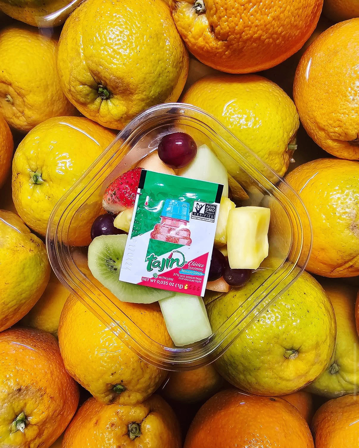 Mixed fruit cup with kiwi, pineapple and grapes over fresh citrus